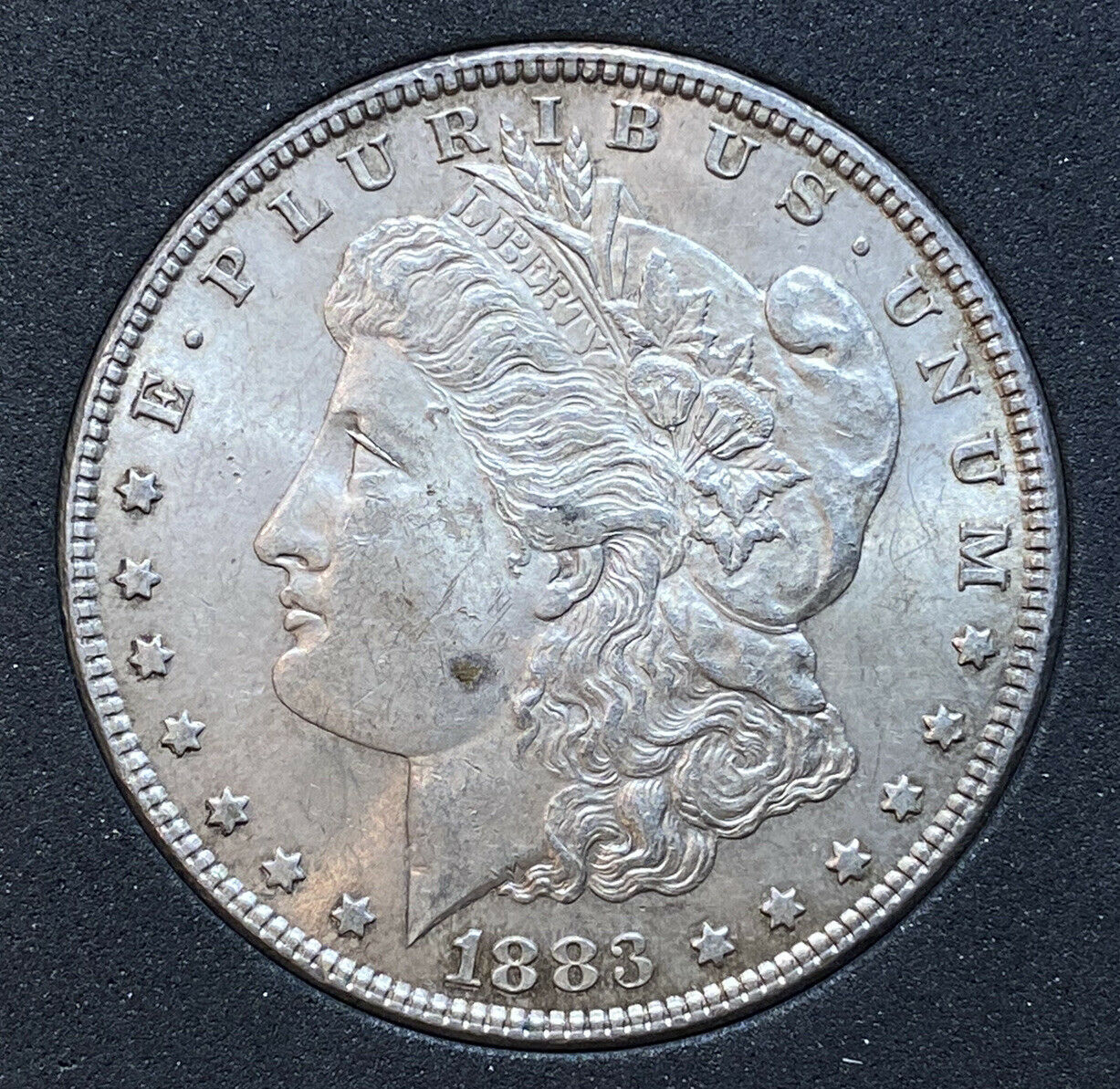 1883 P Morgan Silver Dollar $1 - Bu Toned